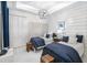 Stylish bedroom with two twin beds, coastal decor, and ample natural light. A comfortable retreat at 256 Van Gogh Cv, Bradenton, FL 34212