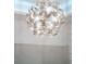 Unique chandelier with a modern design adds a touch of elegance to the room's interior at 256 Van Gogh Cv, Bradenton, FL 34212