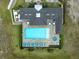An aerial view of a community pool area featuring a hot tub and lounge chairs at 256 Van Gogh Cv, Bradenton, FL 34212