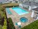 Community pool featuring a hot tub, lounge chairs, and a cabana at 256 Van Gogh Cv, Bradenton, FL 34212