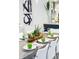 Beautiful dining table with elegant place settings and decorative greenery creating an inviting ambiance for gatherings at 256 Van Gogh Cv, Bradenton, FL 34212