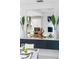 A peek in to the kitchen is seen via a large mirror set above the dining room side board at 256 Van Gogh Cv, Bradenton, FL 34212