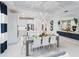Bright open dining space featuring modern lighting, decor, and seamless transition to the kitchen at 256 Van Gogh Cv, Bradenton, FL 34212