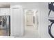 Bright entryway with white tile flooring, leading to a modern kitchen and a welcoming foyer at 256 Van Gogh Cv, Bradenton, FL 34212