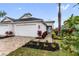 Attractive home exterior featuring a spacious driveway, landscaping, and a two-car garage at 256 Van Gogh Cv, Bradenton, FL 34212