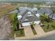 View of a home with a brick driveway, well manicured landscaping, and a water view at 256 Van Gogh Cv, Bradenton, FL 34212