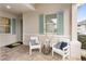 Inviting front porch with stylish seating, coastal decor, and a welcoming ambiance at 256 Van Gogh Cv, Bradenton, FL 34212