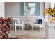 Charming front porch with elegant seating and nautical accents, perfect for relaxation at 256 Van Gogh Cv, Bradenton, FL 34212
