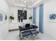 Bright home office featuring a modern desk, comfortable seating, and stylish decor with blue accents at 256 Van Gogh Cv, Bradenton, FL 34212