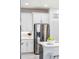 Kitchen featuring stainless steel refrigerator, white cabinets, and modern design elements at 256 Van Gogh Cv, Bradenton, FL 34212