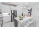 Modern kitchen featuring stainless steel appliances, a stylish island with seating, and contemporary lighting at 256 Van Gogh Cv, Bradenton, FL 34212