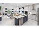 Open-concept kitchen with a large island, stainless steel appliances, and adjacent dining area at 256 Van Gogh Cv, Bradenton, FL 34212