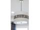 Contemporary light fixture suspended from the ceiling adds a touch of modern elegance to the space at 256 Van Gogh Cv, Bradenton, FL 34212