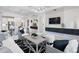 Open living and dining space featuring modern décor, white walls, white tile floors and modern lighting at 256 Van Gogh Cv, Bradenton, FL 34212