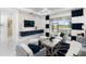 Bright living room with sliding glass doors to a covered lanai, white tile floors, and stylish decor at 256 Van Gogh Cv, Bradenton, FL 34212