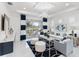 Bright living room features white walls, white tile floors, modern lighting, and stylish decor at 256 Van Gogh Cv, Bradenton, FL 34212