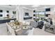 Spacious living room with contemporary decor, dining area and large sliding glass doors providing scenic views at 256 Van Gogh Cv, Bradenton, FL 34212