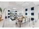 Open-concept living space with dining area, modern lighting, and comfortable seating with beautiful outdoor views at 256 Van Gogh Cv, Bradenton, FL 34212
