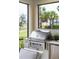 Built-in stainless steel outdoor grill in screened patio area at 256 Van Gogh Cv, Bradenton, FL 34212