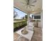 Outdoor kitchen with seating overlooking a lake at 256 Van Gogh Cv, Bradenton, FL 34212