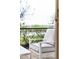 Comfortable patio chair with cushions overlooking a backyard landscape at 256 Van Gogh Cv, Bradenton, FL 34212