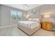 Bedroom featuring a neutral palette, ceiling fan, and stylish window treatments at 27061 Paradise Shores Dr, Englewood, FL 34223