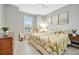 Cozy bedroom with light gray walls, tile flooring, and a sunny window view at 27061 Paradise Shores Dr, Englewood, FL 34223