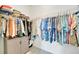 Walk-in closet with hanging racks and shelves for organized storage at 27061 Paradise Shores Dr, Englewood, FL 34223