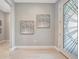 Bright entryway featuring tile flooring, decorative art, and front door with glass design at 27061 Paradise Shores Dr, Englewood, FL 34223