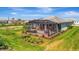Aerial view of a home featuring an outdoor patio with a hot tub and dining table at 27061 Paradise Shores Dr, Englewood, FL 34223