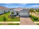 Charming single-story home with a brick driveway and manicured landscaping at 27061 Paradise Shores Dr, Englewood, FL 34223