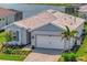 Beautiful single-story home with a two-car garage and well-maintained landscaping near the water at 27061 Paradise Shores Dr, Englewood, FL 34223