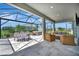 Spacious lanai with a hot tub, dining table, and cushioned chairs at 27061 Paradise Shores Dr, Englewood, FL 34223