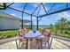 Outdoor dining table with colorful cushioned chairs overlooking a lake at 27061 Paradise Shores Dr, Englewood, FL 34223