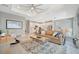 Bright, open-concept living room with views into the modern white kitchen at 27061 Paradise Shores Dr, Englewood, FL 34223