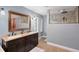 Bright bathroom featuring a dual sink vanity with a glass enclosed walk in shower at 2833 Bay Shore Cir, Sarasota, FL 34234