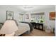 Bright bedroom featuring hardwood floors, two large windows and an accent table with decorations at 2833 Bay Shore Cir, Sarasota, FL 34234