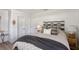 Modern bedroom with a decorative headboard, soft bedding and a plush gray throw blanket at 2833 Bay Shore Cir, Sarasota, FL 34234