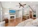 Open bedroom with wood flooring, fireplace, large television and built in shelves at 2833 Bay Shore Cir, Sarasota, FL 34234
