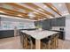 Modern kitchen featuring a large center island with bar seating, professional appliances, and wood beam ceiling at 2833 Bay Shore Cir, Sarasota, FL 34234