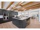 Modern kitchen featuring a large center island, professional appliances and wood beam ceiling at 2833 Bay Shore Cir, Sarasota, FL 34234