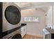 Contemporary laundry room with a modern washer/dryer unit and plenty of storage space at 2833 Bay Shore Cir, Sarasota, FL 34234