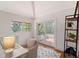 Bright office with a desk, chair, and french doors opening to a private outdoor patio space with leafy views at 2833 Bay Shore Cir, Sarasota, FL 34234