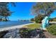 Lovely waterfront view featuring sidewalk, bay, and tropical statue at 2833 Bay Shore Cir, Sarasota, FL 34234