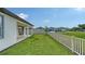 Spacious backyard with healthy green grass, fence line, and a view of neighboring houses at 2907 61St E Ter, Ellenton, FL 34222