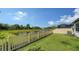 A well-maintained backyard offers a serene view of a pond and lush greenery at 2907 61St E Ter, Ellenton, FL 34222