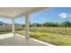 Covered patio with scenic views of a grassy backyard and white picket fence at 2907 61St E Ter, Ellenton, FL 34222