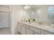 Elegant bathroom with double vanity, white countertops, and modern fixtures, offering a luxurious feel at 2907 61St E Ter, Ellenton, FL 34222