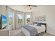 Sunlit bedroom with large windows and a comfortable bed with blue accents at 2907 61St E Ter, Ellenton, FL 34222
