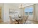 Elegant dining room with a modern chandelier, neutral decor, and ample natural light at 2907 61St E Ter, Ellenton, FL 34222